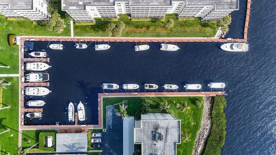 An aerial view shows a residential marina with multiple boats docked along wooden piers — 1 Harbourside Drive # 4205, Delray Beach FL 33483, DELRAY BEACH, FL