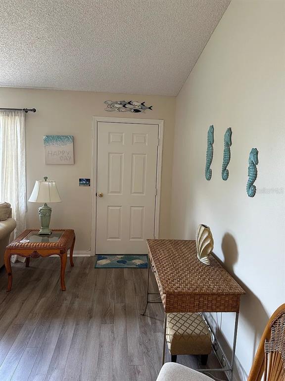 A living area features a white door, wicker furniture, and coastal-themed wall decor — 17808 SE 107TH TERRACE, SUMMERFIELD, FL