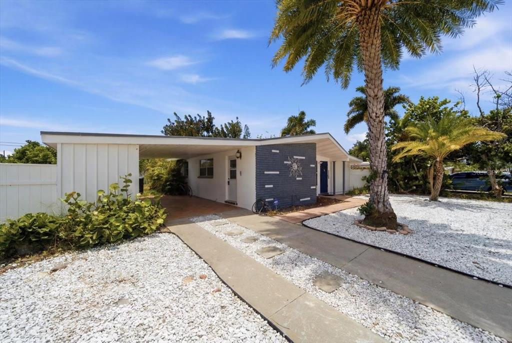 A single-story house with a carport, a gray brick accent wall, and white gravel landscaping — 2316 HOLYOKE AVENUE, BRADENTON, FL