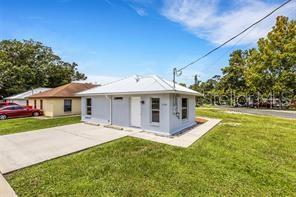 A light blue, single-story house with a metal roof and a concrete driveway — 3100 W REYNOLDS STREET, PLANT CITY, FL