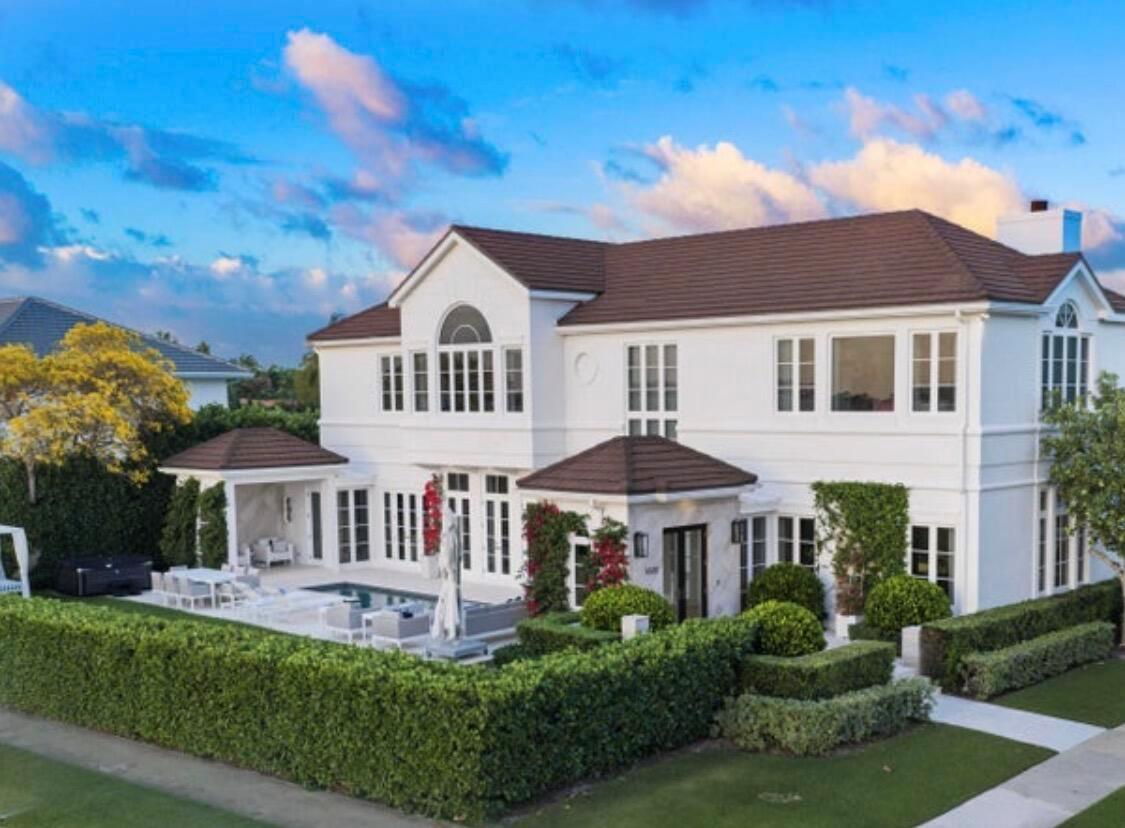 A two-story white house with a brown roof, swimming pool, and manicured hedge landscaping — 5501 S Flagler Drive, West Palm Beach FL 33405, WEST PALM BEACH, FL