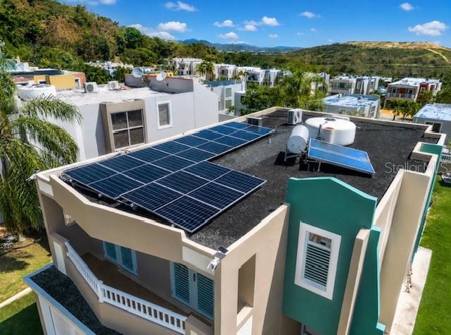 An aerial view of a flat roof featuring solar panels and a solar water heater — Camino del Miradero 09, HUMACAO, PR
