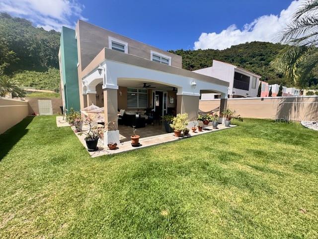 A two-story house with a covered patio and a large grassy backyard — Camino del Miradero 09, HUMACAO, PR