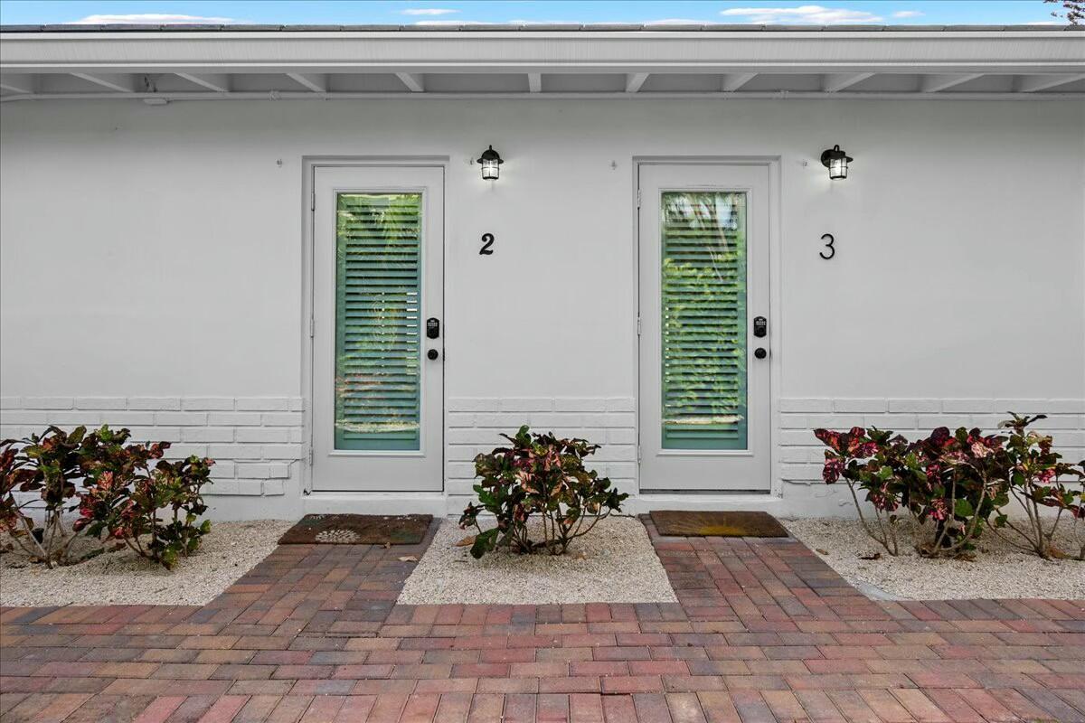 Two white doors labeled 2 and 3 are set in a white exterior wall — 18 Adams Road, Ocean Ridge FL 33435, OCEAN RIDGE, FL
