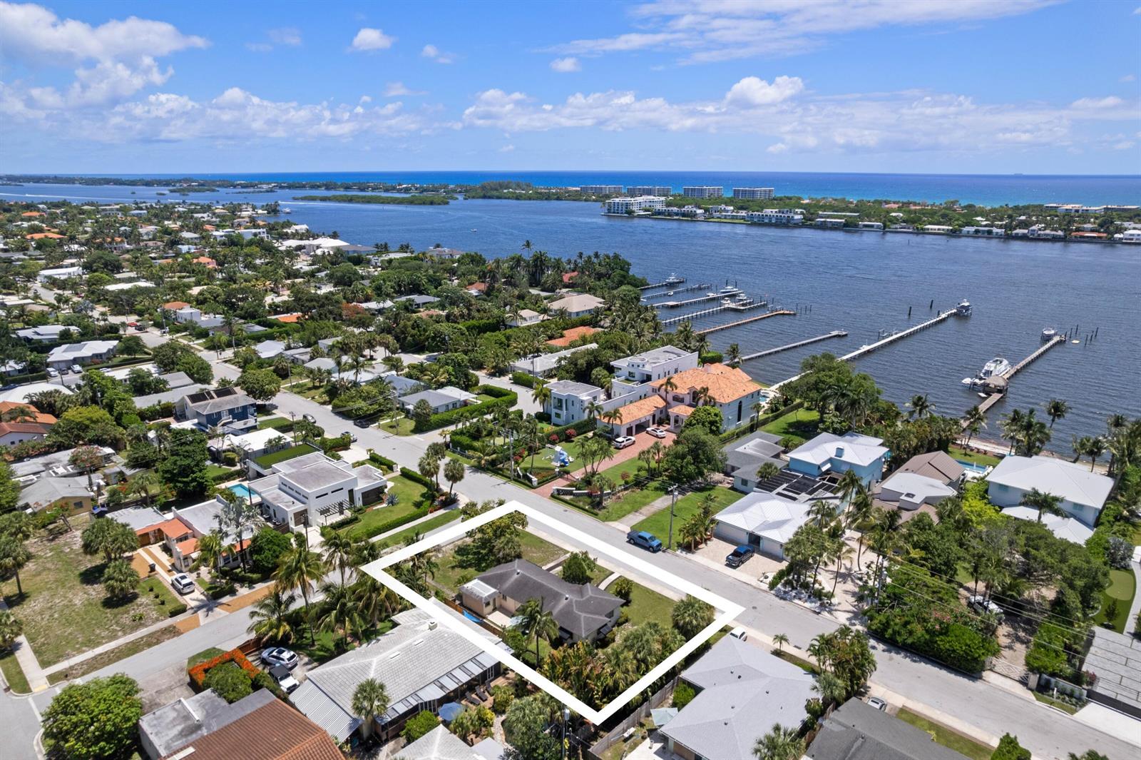 An aerial view shows a single-story house with a white outline on a residential street — 1725 N Lakeside Drive, FL 33460, FL