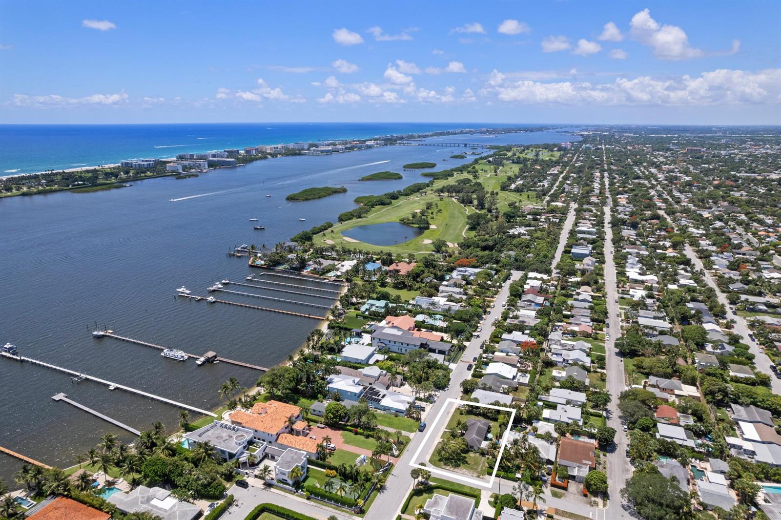 An aerial view shows a residential property highlighted in a white outline near the water — 1725 N Lakeside Drive, FL 33460, FL