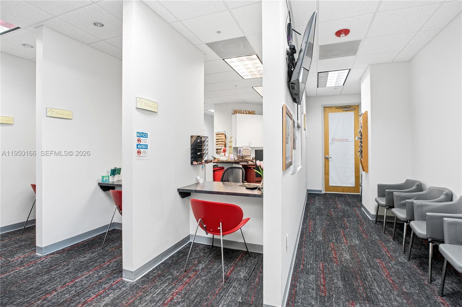 A medical office reception area features two check-in stations, a waiting area, and carpeted floors — 3650 NW 82nd Ave, Doral FL 33166, DORAL, FL