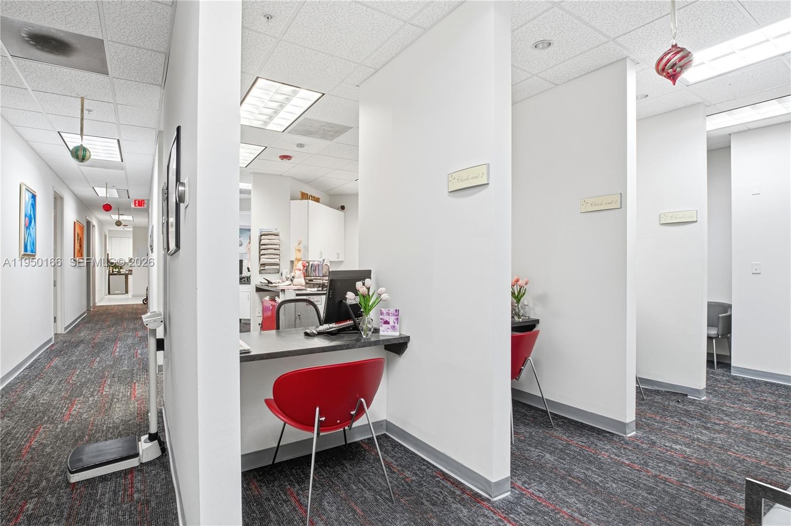 A medical office hallway features three partitioned workstations with red chairs and gray carpeting — 3650 NW 82nd Ave, Doral FL 33166, DORAL, FL