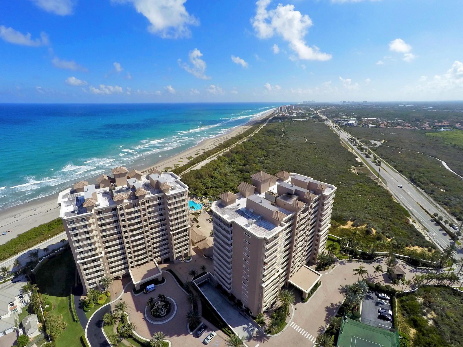 Aerial view of two high-rise apartment buildings situated between the ocean and a highway — 700 Ocean Royale Way # 401, Juno Beach FL 33408, JUNO BEACH, FL