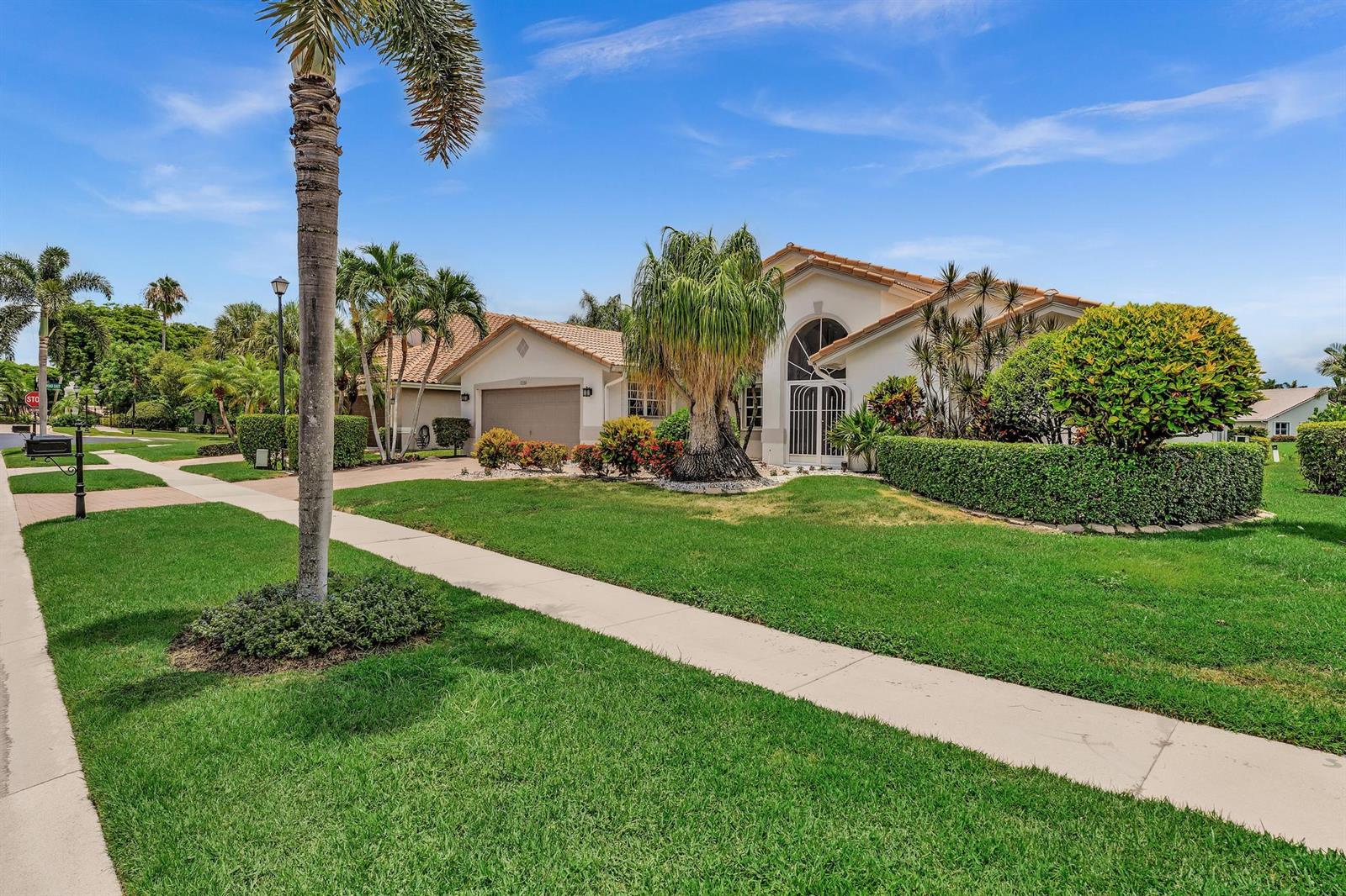 A single-story house with a tile roof, a two-car garage, and a landscaped front yard — 12316 Lakeridge Falls Drive, Boynton Beach FL 33437, BOYNTON BEACH, FL