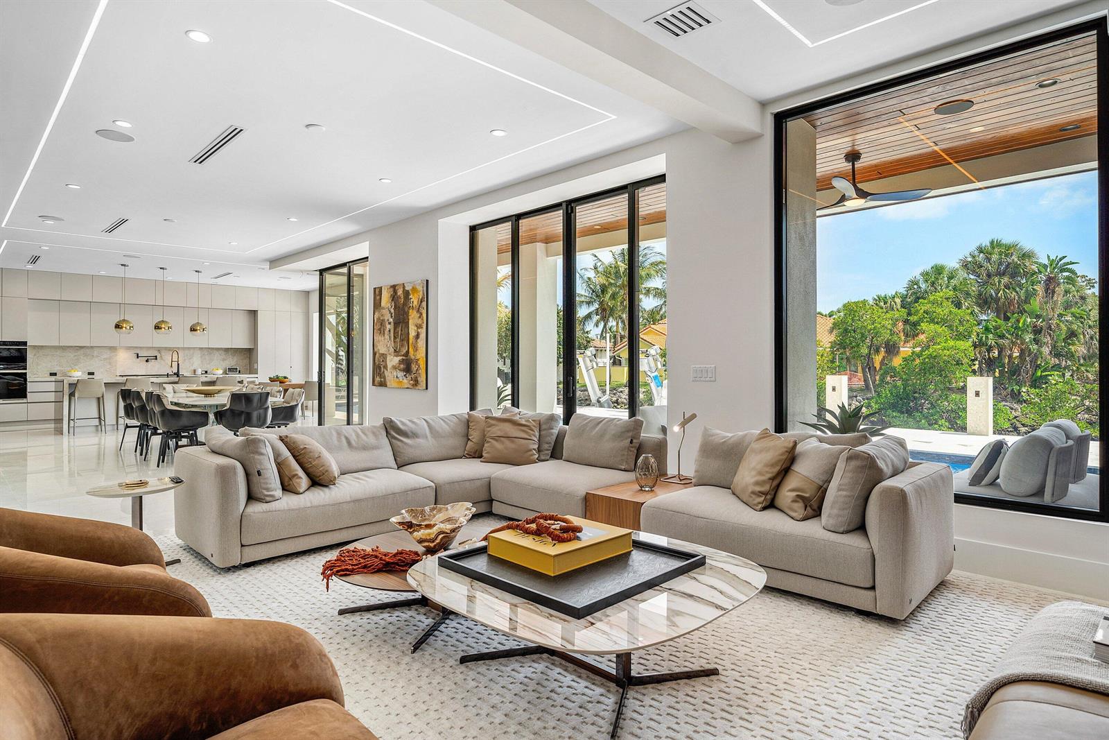 A modern living room with a large sectional sofa, marble coffee table, and floor-to-ceiling windows — 798 Havana Drive, Boca Raton FL 33487, BOCA RATON, FL