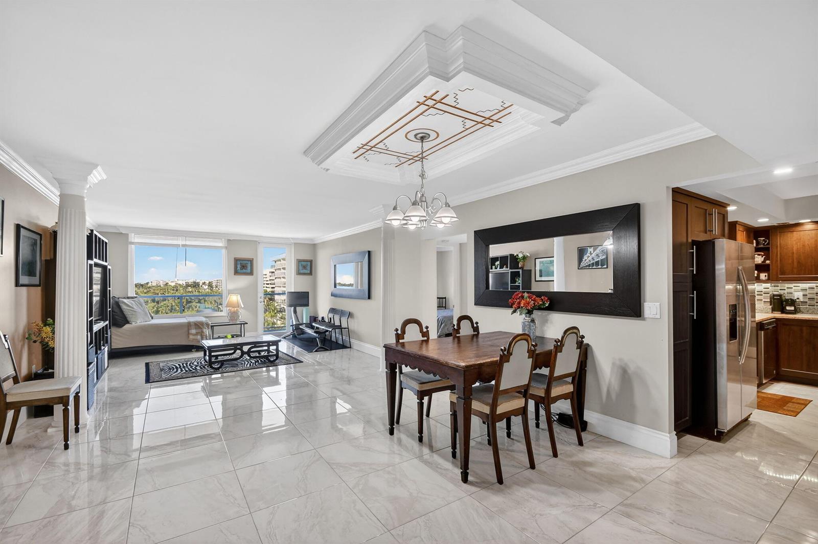 A dining area and living room with tile floors, a coffered ceiling, and balcony views — 3450 S Ocean Boulevard # 423, Palm Beach FL 33480, PALM BEACH, FL