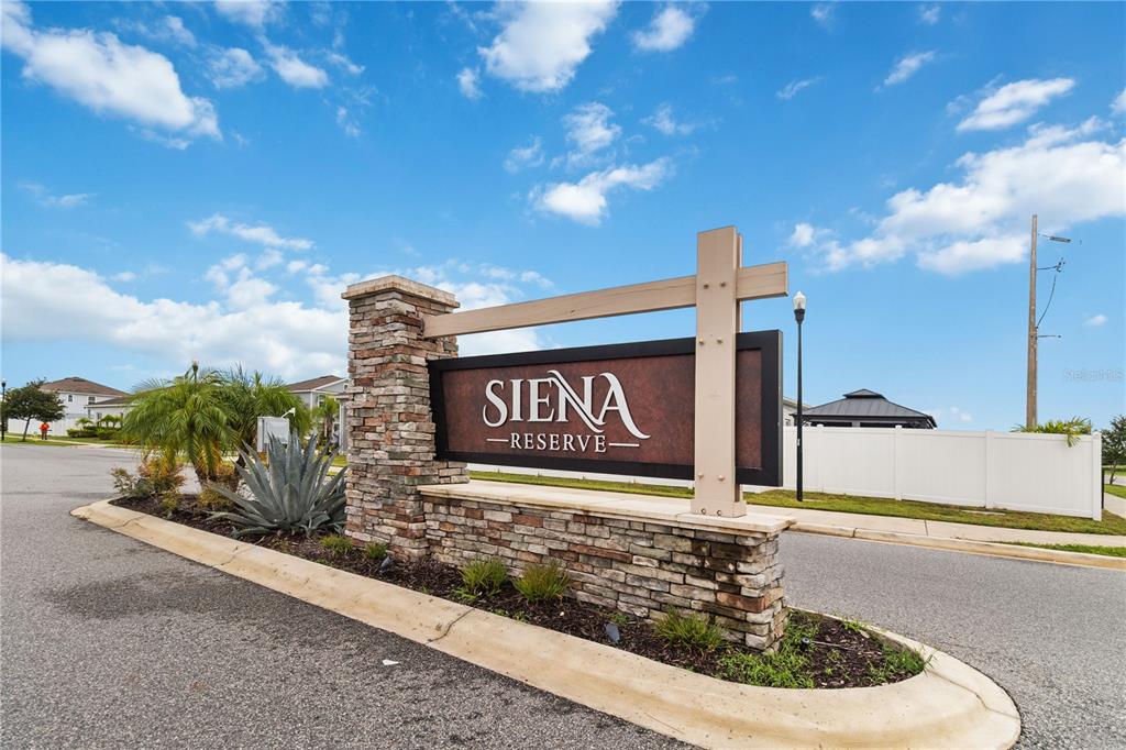 A stone monument sign for Siena Reserve stands at the entrance of a residential community — 5581 VIGO LOOP, ST CLOUD, FL