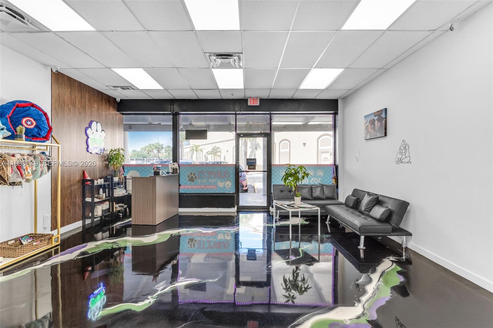 A pet shop interior features a black epoxy floor, a reception desk, and seating area — 13790 SW 56th St, Miami FL 33183, MIAMI, FL