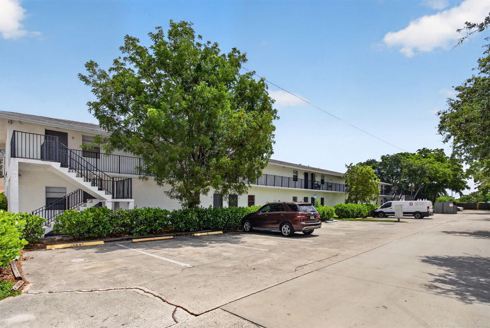 A two-story apartment building with exterior staircases and a parking lot in front — 1300 NW 2nd Avenue # 12, Pompano Beach FL 33060, POMPANO BEACH, FL