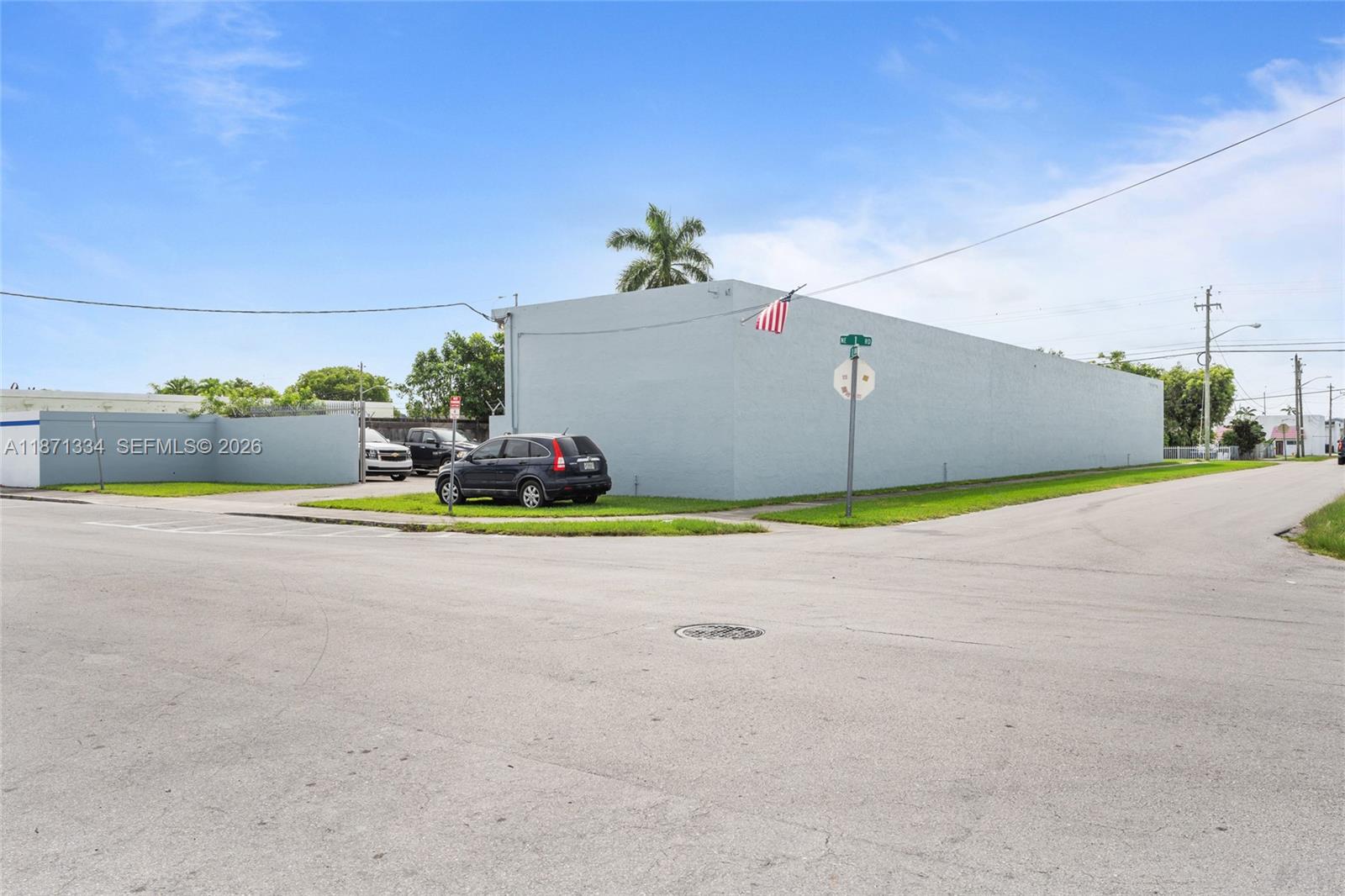 A light blue commercial building sits on a corner lot with a parked SUV — 105 NE 1st Rd, Homestead FL 33030, HOMESTEAD, FL