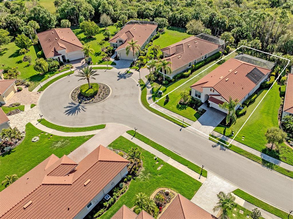 An aerial view shows several suburban houses with tiled roofs and landscaped yards — 500 PADOVA WAY, NORTH VENICE, FL