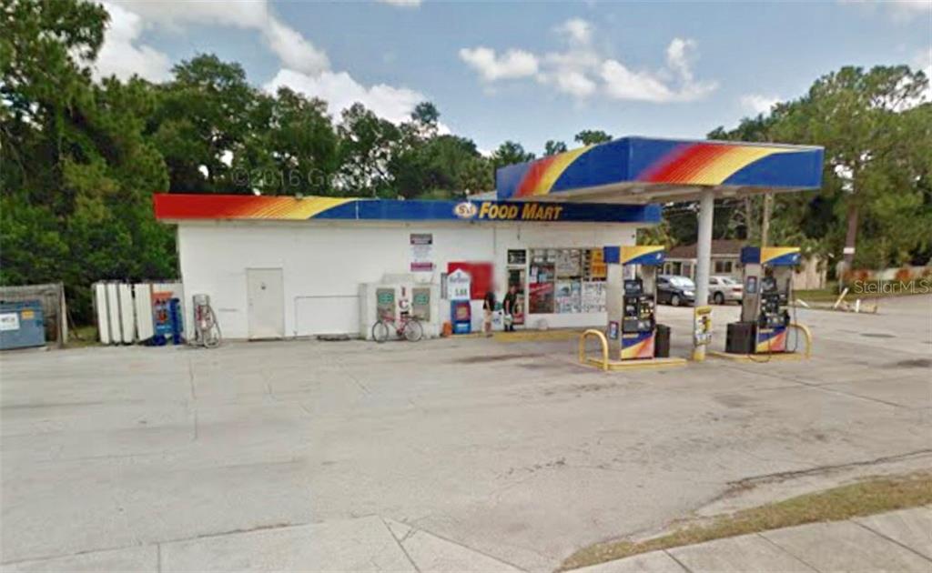 A gas station with a food mart and fuel pumps under a colorful canopy — 123 S US 17-92, DEBARY, FL