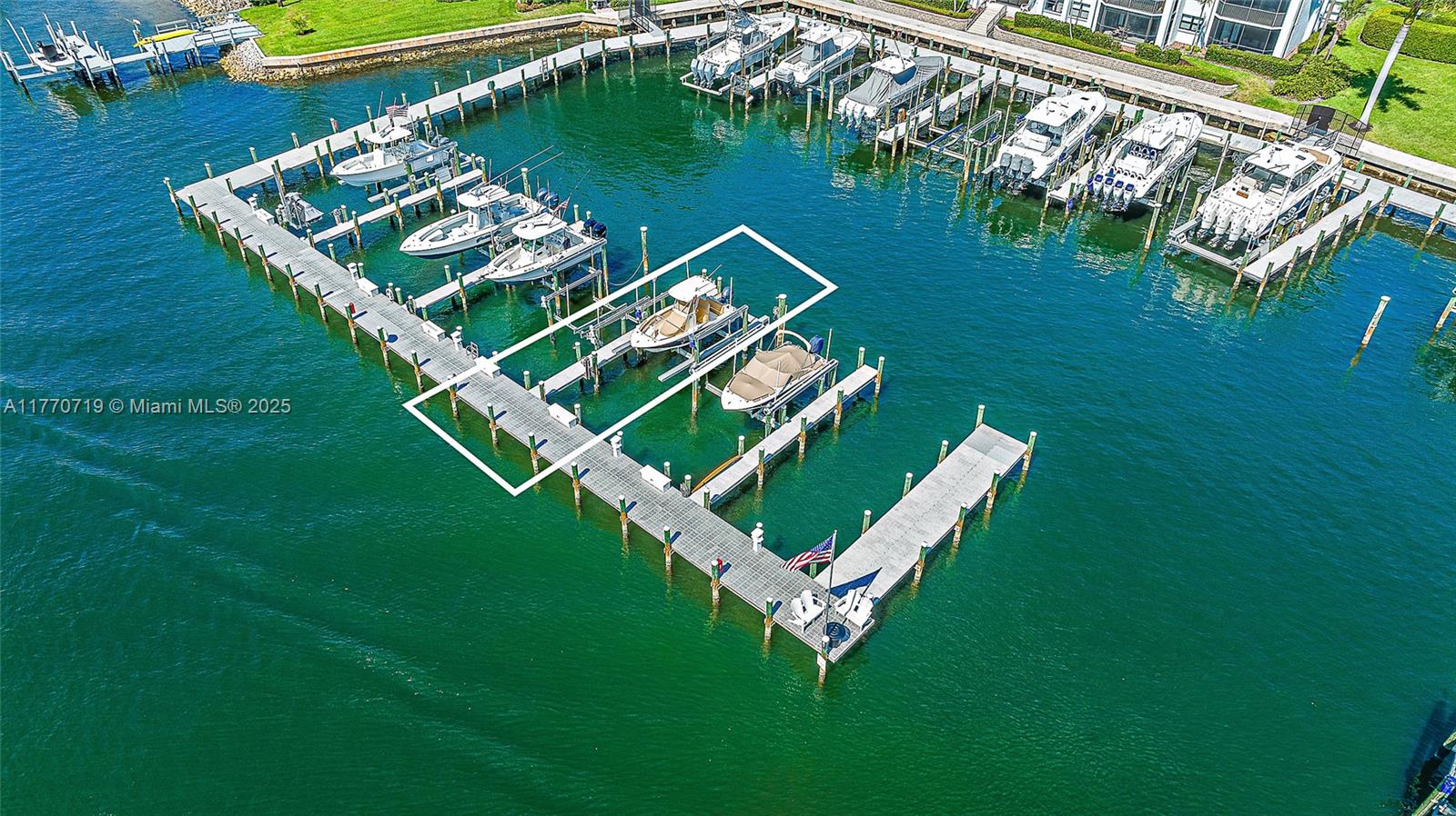 An aerial view shows a marina with multiple boats docked at wooden piers — 1015 S Bay Colony Drive S Slip 17, Juno Beach FL 33408, JUNO BEACH, FL