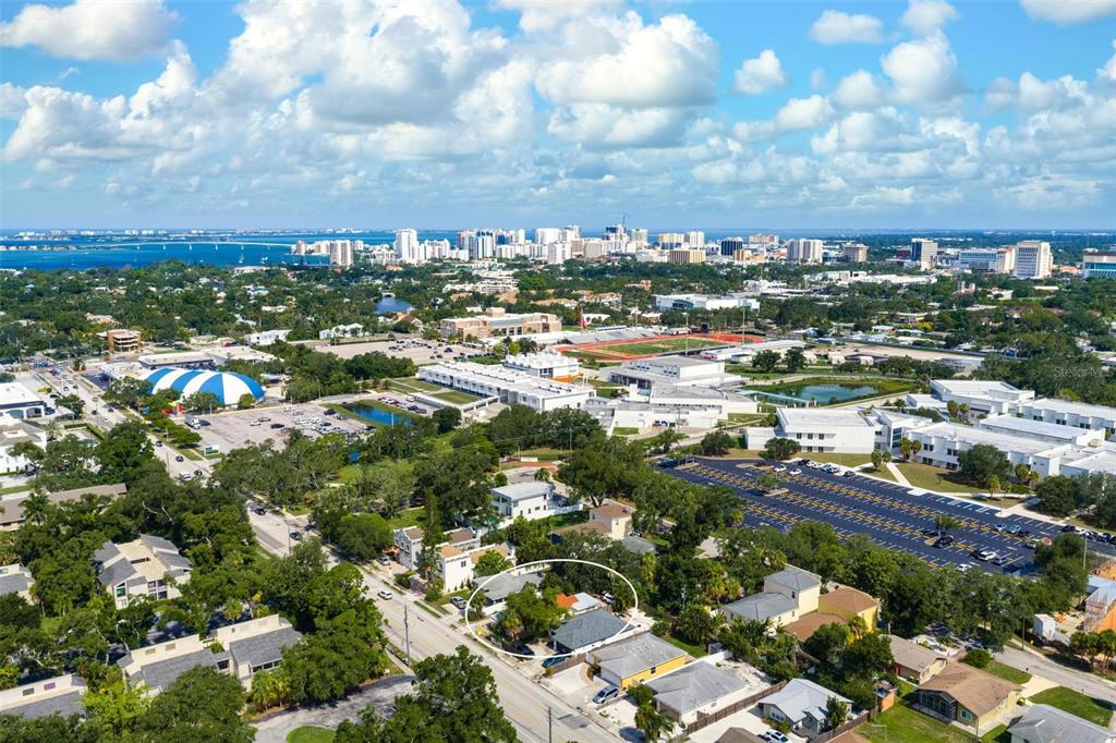 An aerial view shows a residential neighborhood with a circled house near a large school — 2245 BAHIA VISTA STREET, SARASOTA, FL