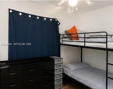 A bedroom features a black metal bunk bed, a dark dresser, and a dark curtain — 1020 NW 143rd St, Miami FL 33168, MIAMI, FL