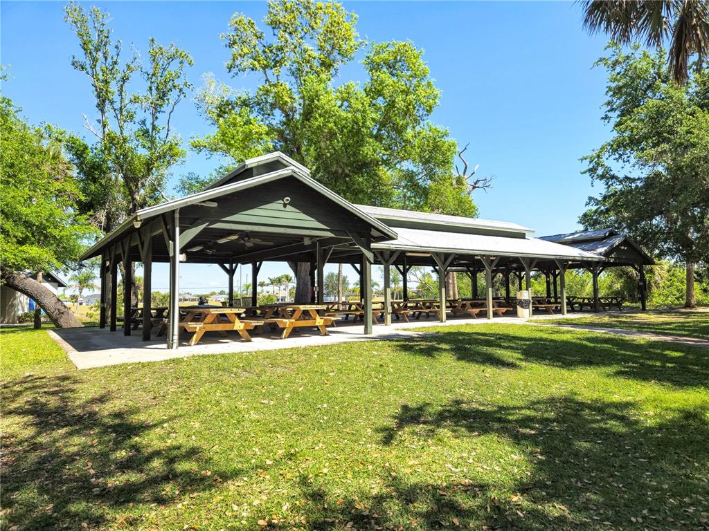 A large, open-air covered pavilion with picnic tables sits on a grassy park lawn — 17240 CAPE HORN BOULEVARD, PUNTA GORDA, FL