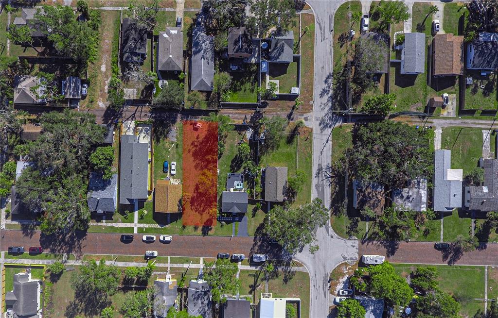 An aerial view shows a vacant, rectangular lot highlighted in red between two residential houses — 3530 2ND AVENUE S, ST PETERSBURG, FL