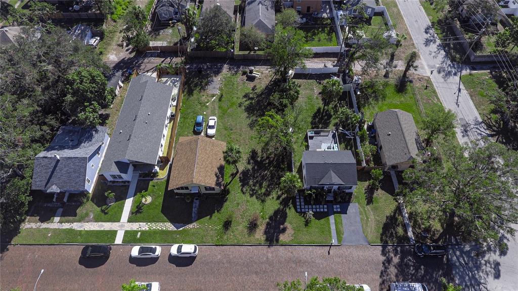 An aerial view shows four houses situated along a street with trees and grassy yards — 3530 2ND AVENUE S, ST PETERSBURG, FL