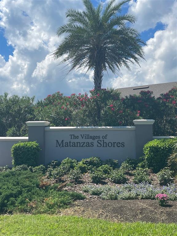A stone monument sign for The Villages of Matanzas Shores stands before a palm tree — 11 SAN LUIS LANE, PALM COAST, FL