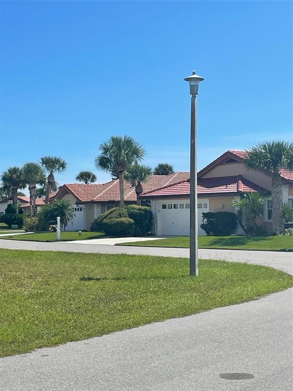 A street view shows residential houses with red tile roofs and palm trees — 11 SAN LUIS LANE, PALM COAST, FL