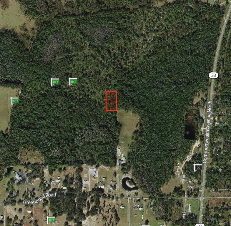 An aerial map view shows a rectangular property highlighted in red within a wooded area — POLK CITY, POLK CITY, FL