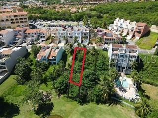 An aerial view shows a vacant rectangular lot outlined in red within a residential complex — 1 MONTECARLO UNIT 149, HUMACAO, PR