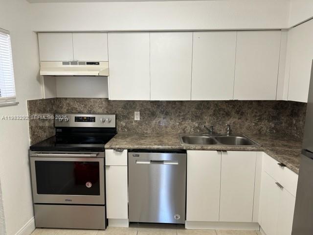 A kitchen features white cabinets, stainless steel appliances, and a dark brown patterned countertop — 4255 N UNIVERSITY DR # 215, Sunrise FL 33351, SUNRISE, FL