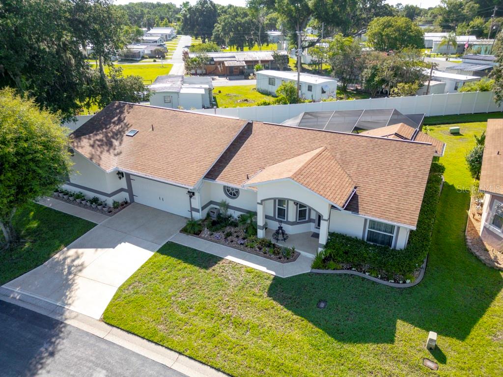 An aerial view of a single-story house with a brown shingled roof and driveway — 6323 SILVER LAKES DRIVE E, LAKELAND, FL