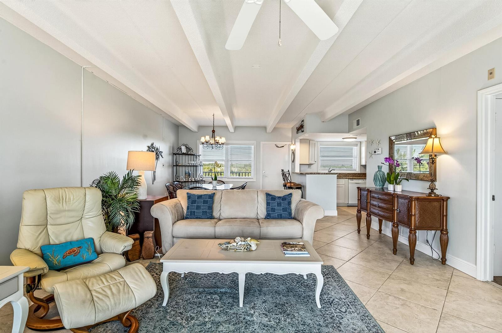 A living room with a beige sofa, a recliner, and a wooden console table — 4410 Highway A1a # 307, Vero Beach FL 32963, VERO BEACH, FL