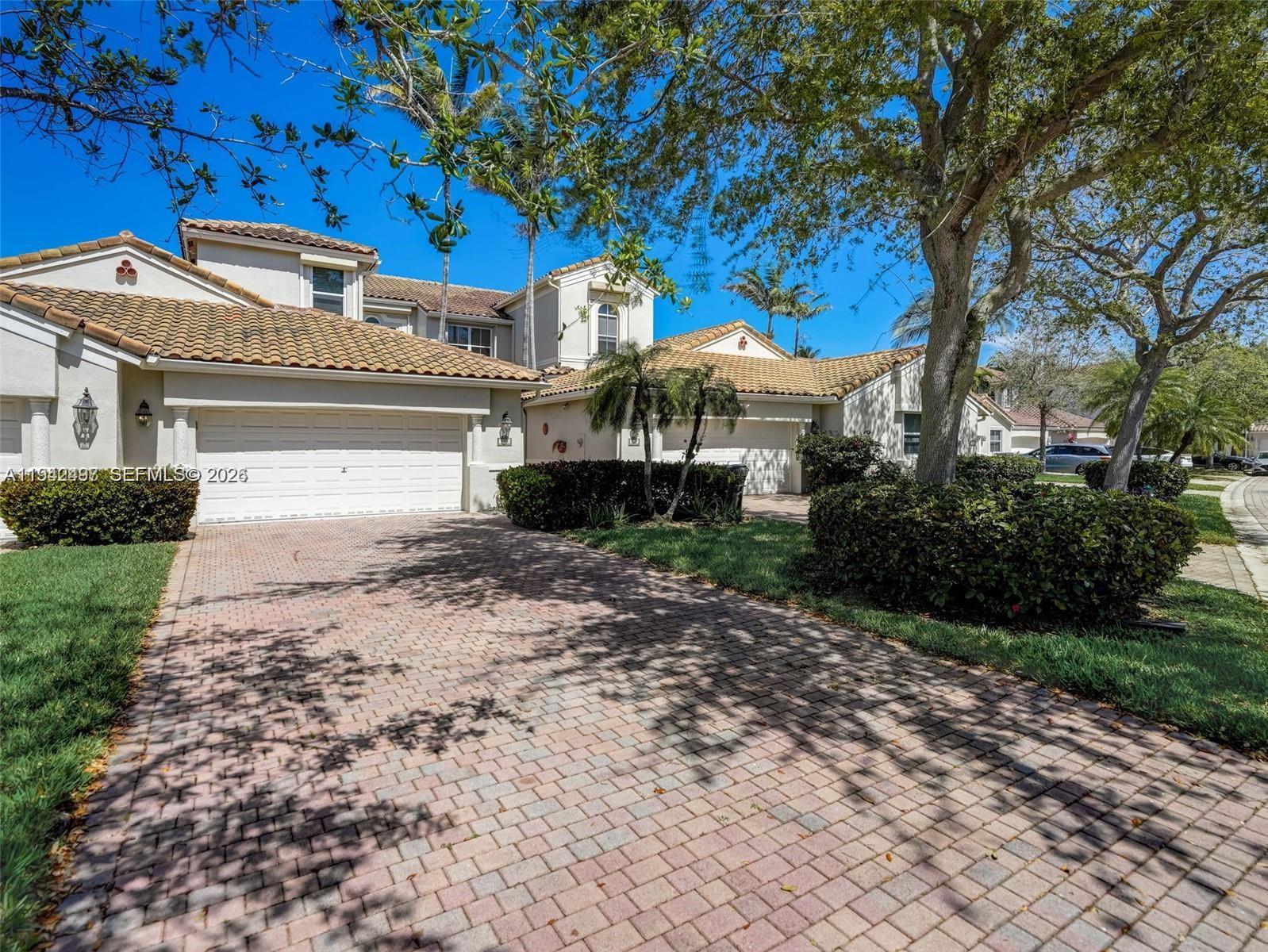 A two-story house with a tiled roof, a brick driveway, and mature landscaping — 963 S Harbor Vw S, Hollywood FL 33019, HOLLYWOOD, FL