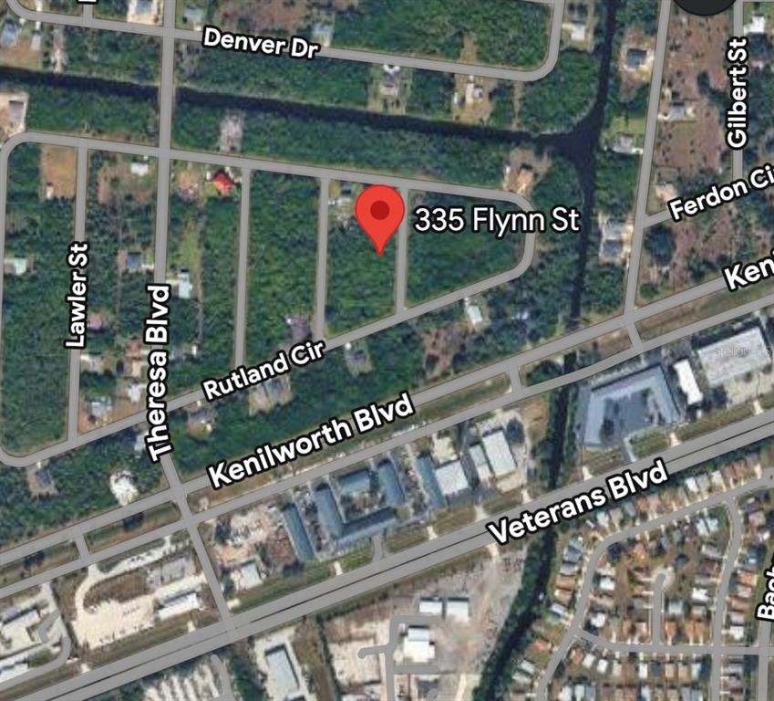 This is a satellite map view showing a vacant lot marked with a red pin — 335 FLYNN STREET, PORT CHARLOTTE, FL