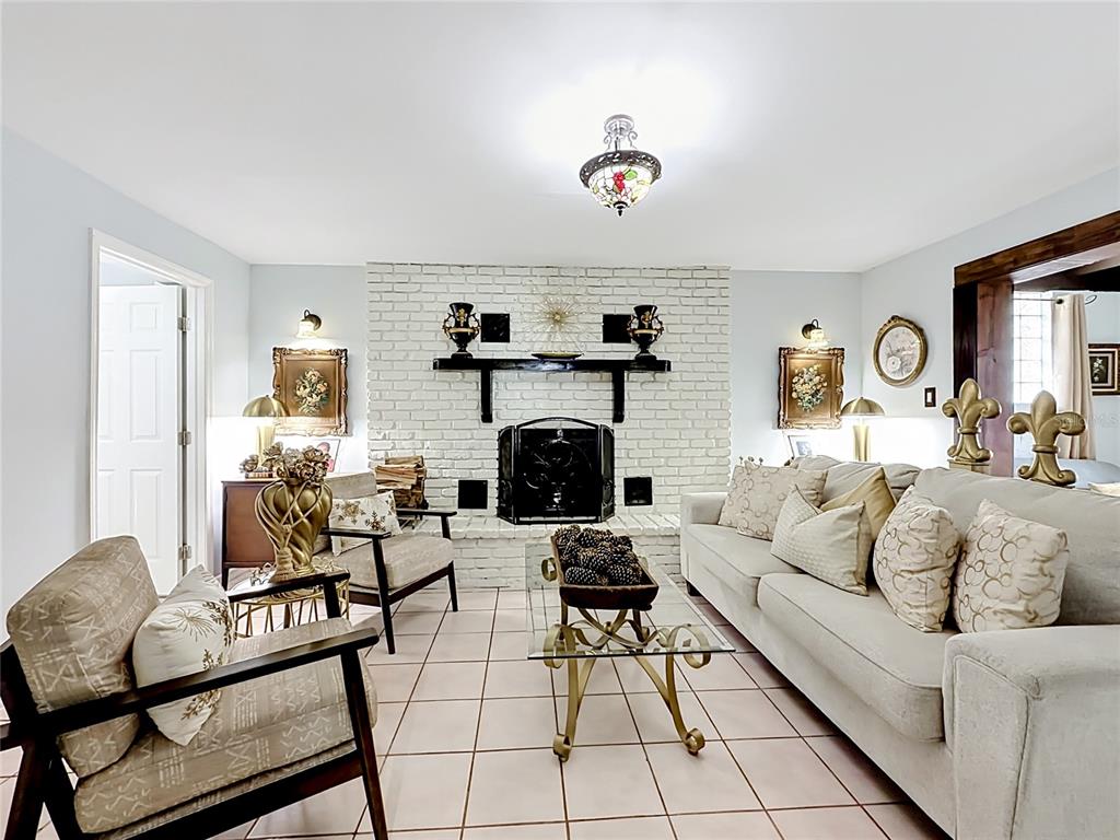 An aerial view shows a single-story house with a white exterior, palm trees, and driveway — 2705 ARC DRIVE, ORLANDO, FL