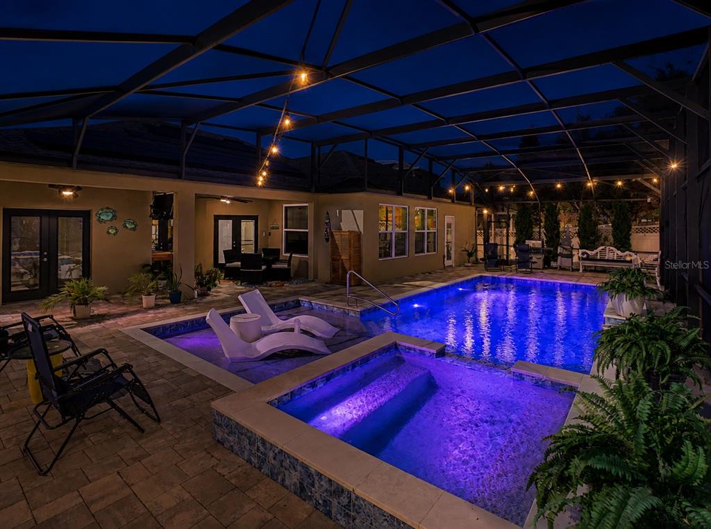 A single-story suburban house with a two-car garage, solar panels, and a landscaped front yard — 2260 PICKFORD CIRCLE, APOPKA, FL