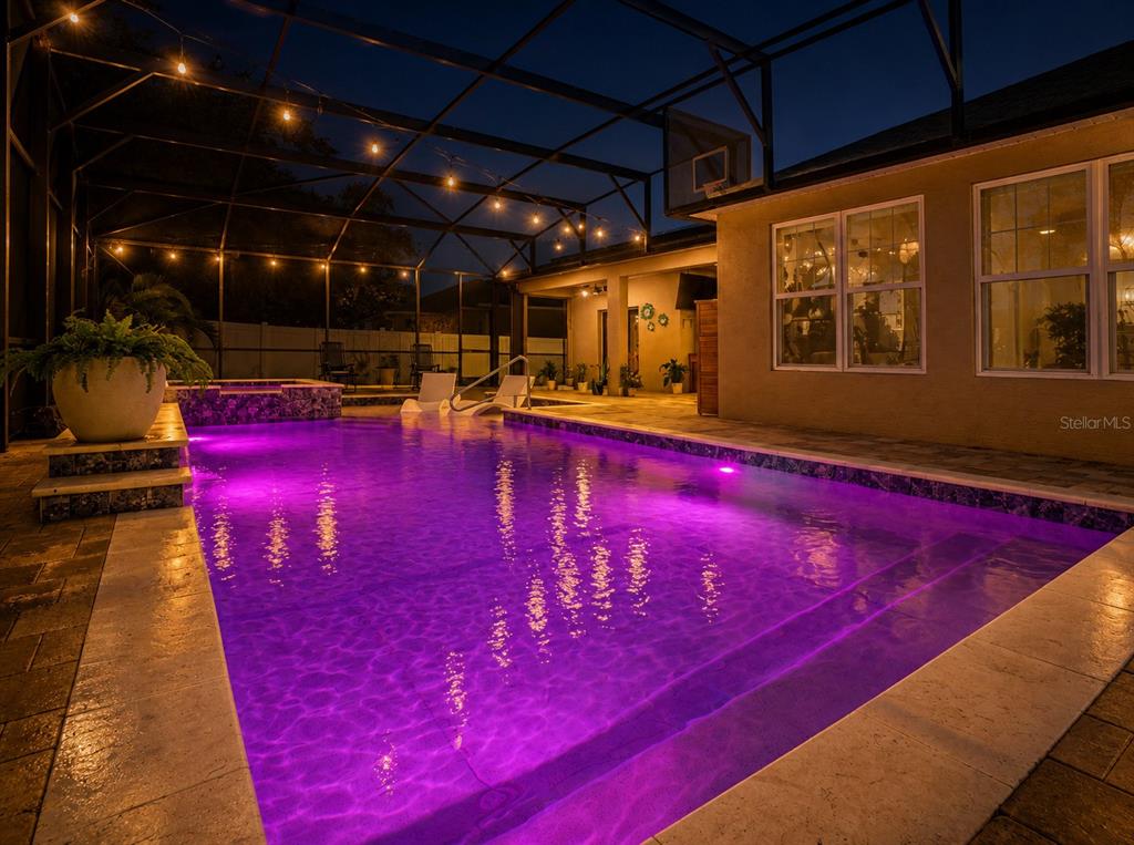 A single-story house with a tan stucco exterior, solar panels, and a landscaped front yard — 2260 PICKFORD CIRCLE, APOPKA, FL