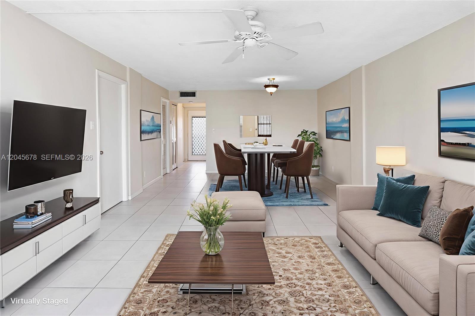 This living and dining room features tile flooring, a ceiling fan, and neutral-toned furniture — 505 E Dania Beach Blvd # 3G, Dania Beach FL 33004, DANIA BEACH, FL