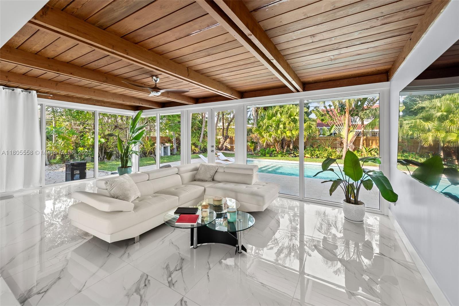An aerial view shows a residential neighborhood with palm trees, swimming pools, and a bay — 1025 Washington St, Hollywood FL 33019, HOLLYWOOD, FL