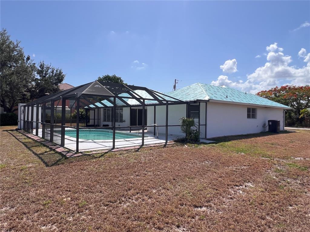 The exterior of a house with a swimming pool enclosed by a screened lanai — 4419 CREWS COURT, PORT CHARLOTTE, FL