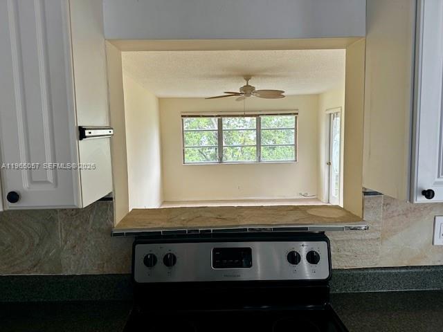 An empty room features beige tile flooring, a ceiling fan, and a large window — 2223 Park Ln # 304, Hollywood FL 33021, HOLLYWOOD, FL