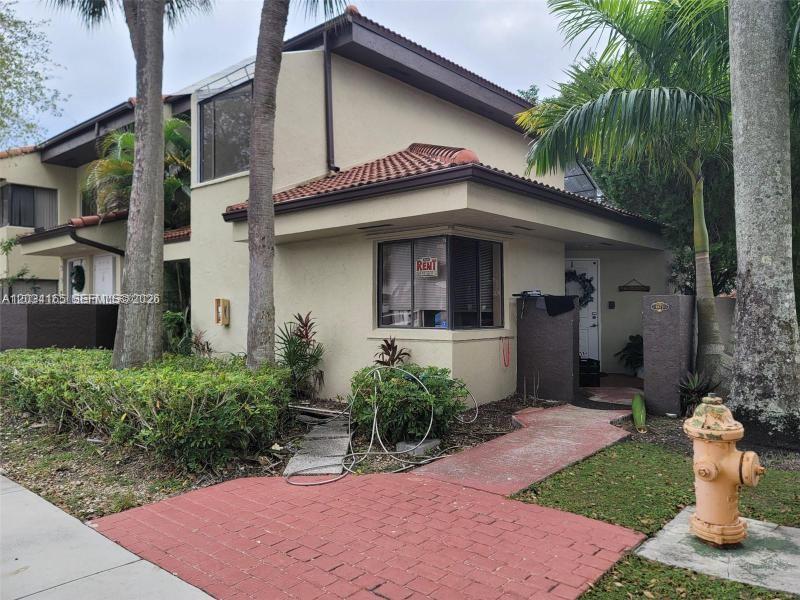 A two-story tan townhouse with a red-tiled roof and a fire hydrant in front — 9673 SW 138th Ave, Miami FL 33186, MIAMI, FL
