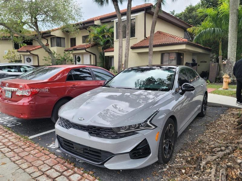 A gray Kia sedan is parked in front of a multi-story residential building — 9673 SW 138th Ave, Miami FL 33186, MIAMI, FL
