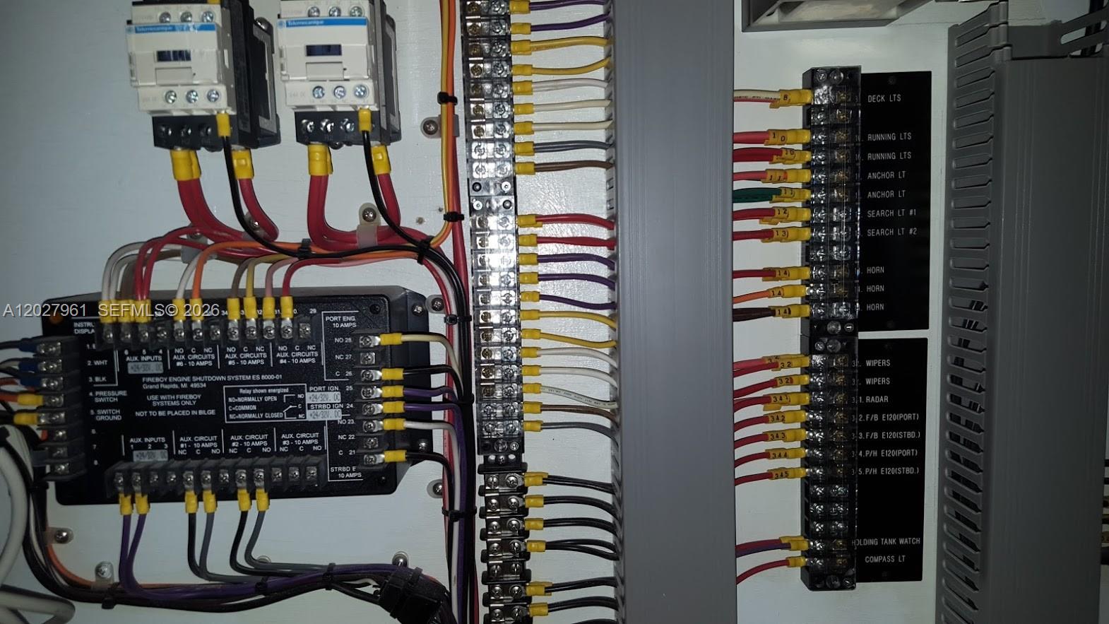 This image shows an electrical control panel with labeled wiring terminals and a Fireboy shutdown system — MIAMI, FL