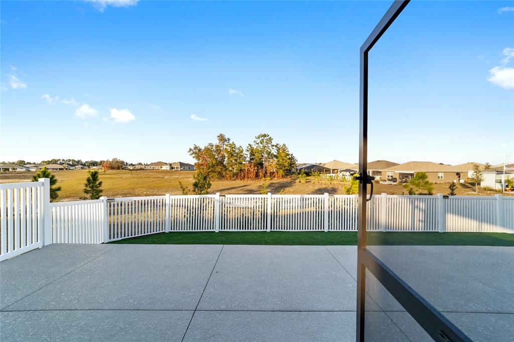 A single-story house with a stone-accented facade, a three-car garage, and a paved driveway — 10453 SW 99TH LANE, OCALA, FL