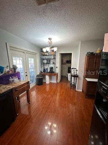 A dining area with hardwood floors, a chandelier, French doors, and a wooden hutch — 4325 CAROLYN WAY, BARTOW, FL