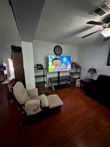 A living room with hardwood floors, a television on a stand, and a beige recliner — 4325 CAROLYN WAY, BARTOW, FL